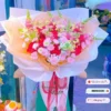 Bó hoa tươi cắm sẵn với tone hồng cam pastel, được trưng bày trước cửa shop – phù hợp tặng sinh nhật, lễ, chúc mừng.